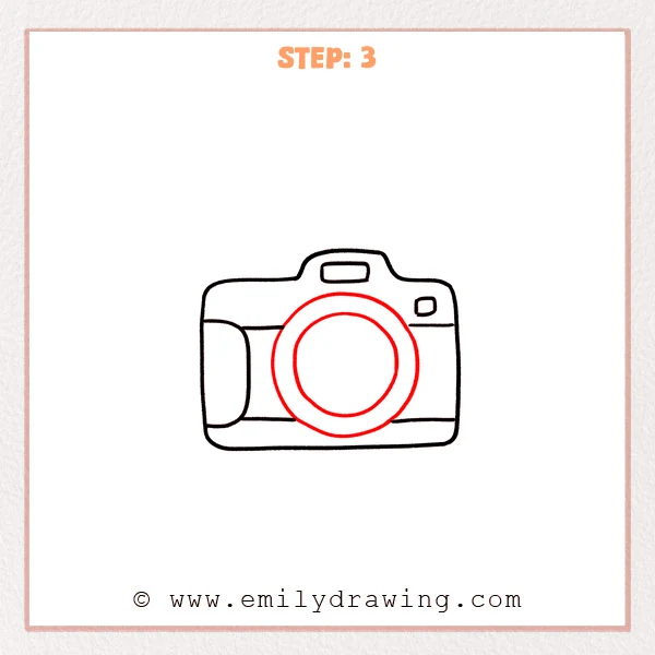 how to draw a camera - Camera drawing with a large central lens ring and a smaller inner circle added inside the lens.